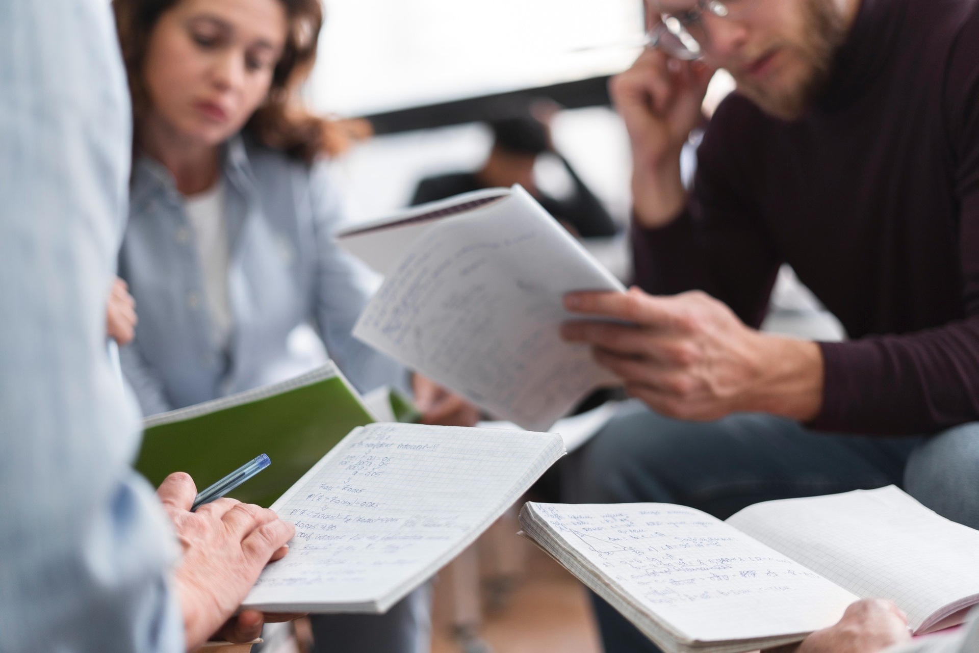 Colleagues reviewing printed documents together