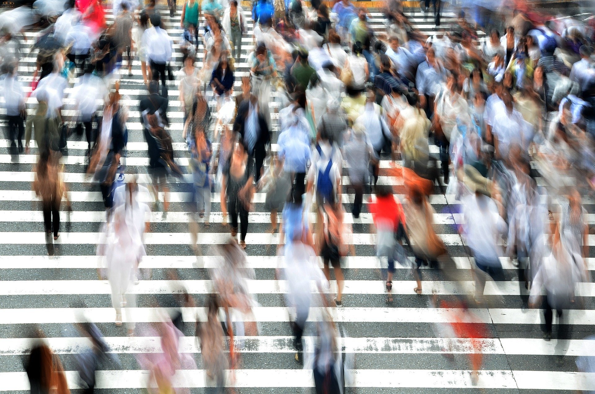 Crowds of pedestrians crossing an urban street