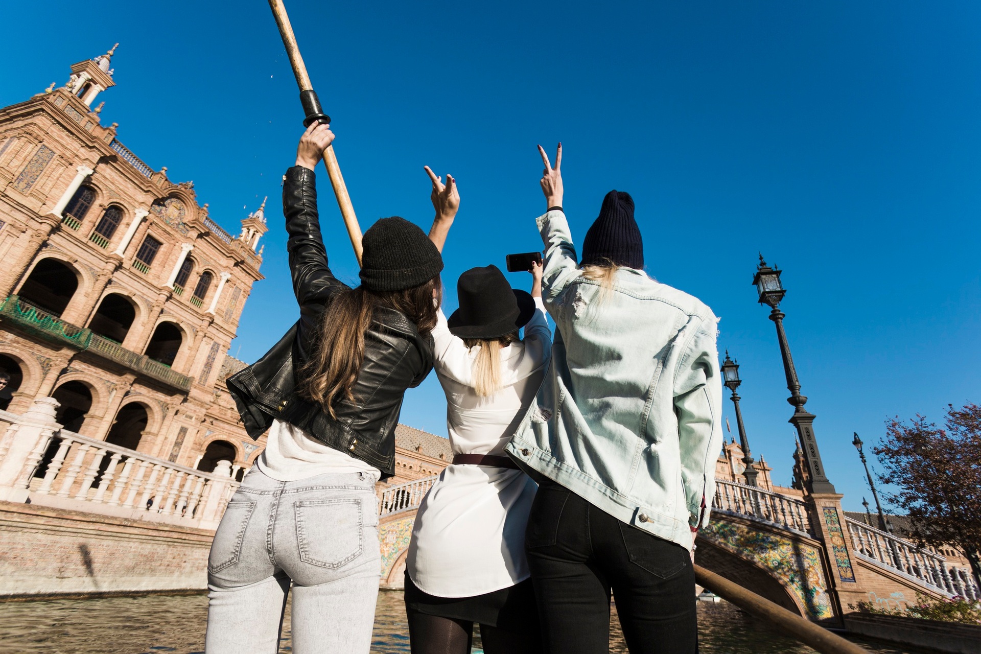 Friends taking a photograph in front of historic architecture
