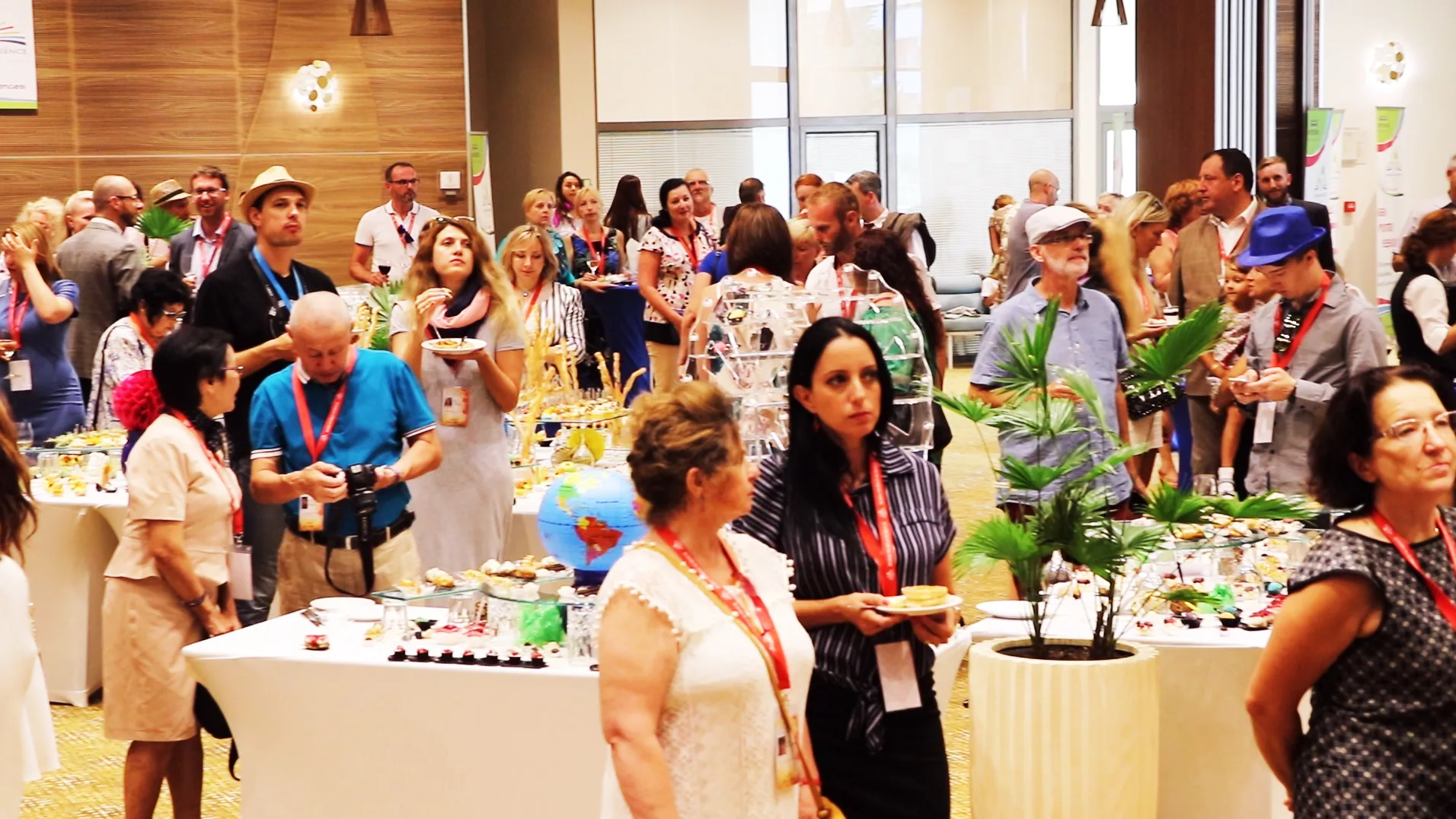 Conference participants gathered around tables at a reception
