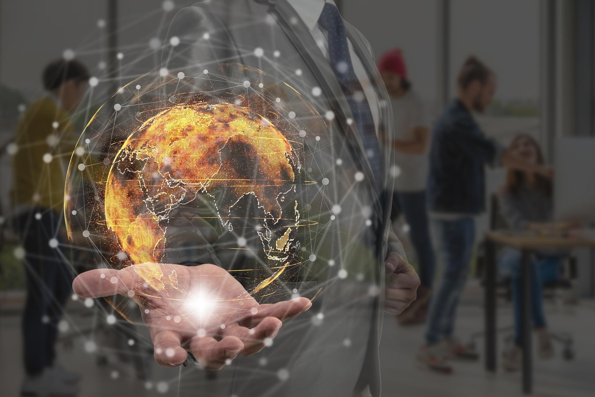 A digital globe and network illustration over a collaborative workspace