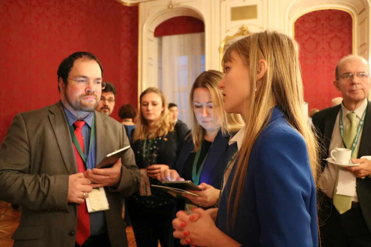 Delegates chatting over refreshments between conference sessions
