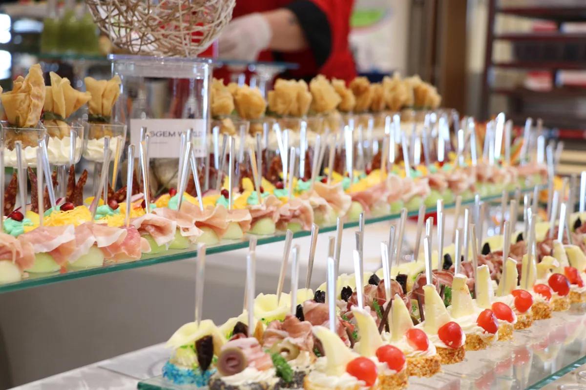 Rows of canapés and small desserts at a conference buffet