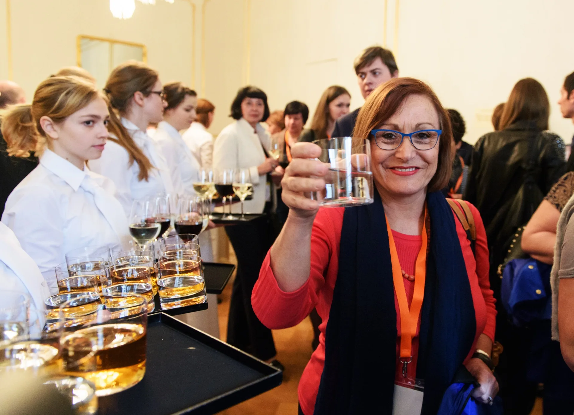 A delegate raising a glass during a conference reception