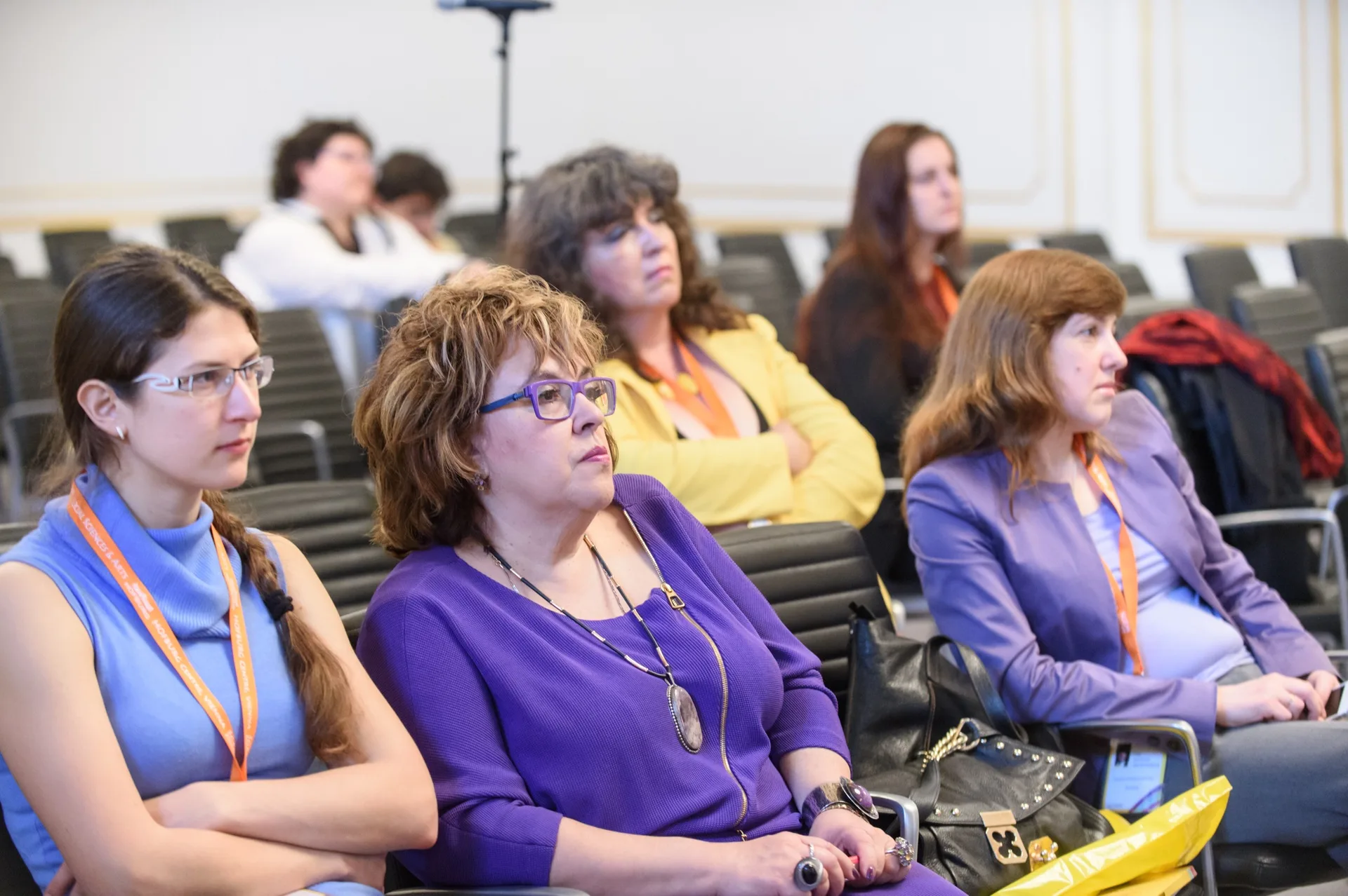 Conference delegates watching a presentation from auditorium seats