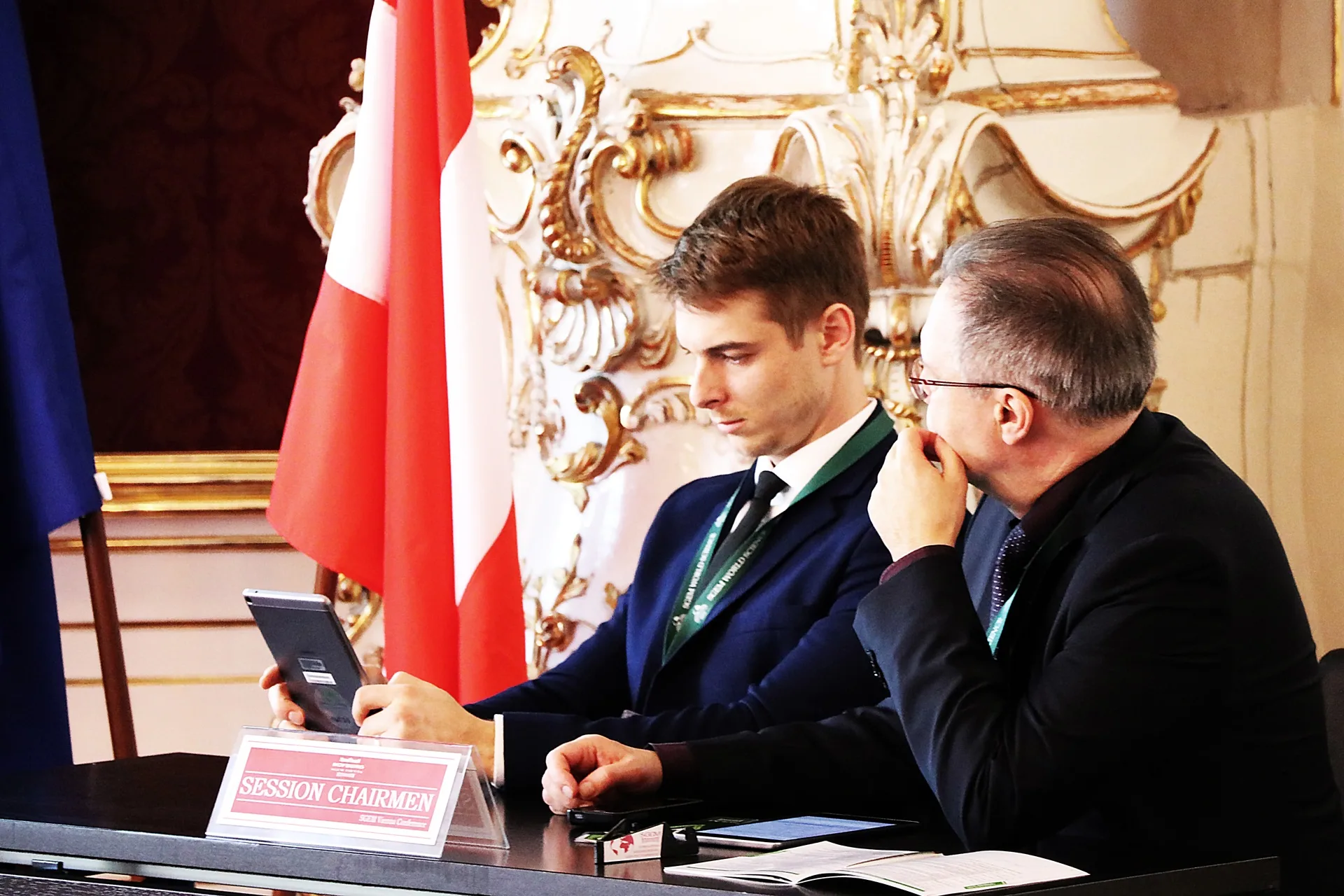 Two session chairpersons consulting at an SGEM conference table