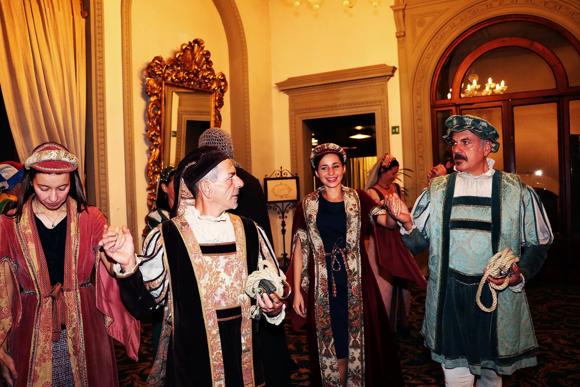 Performers in Renaissance-style costumes at a conference cultural event