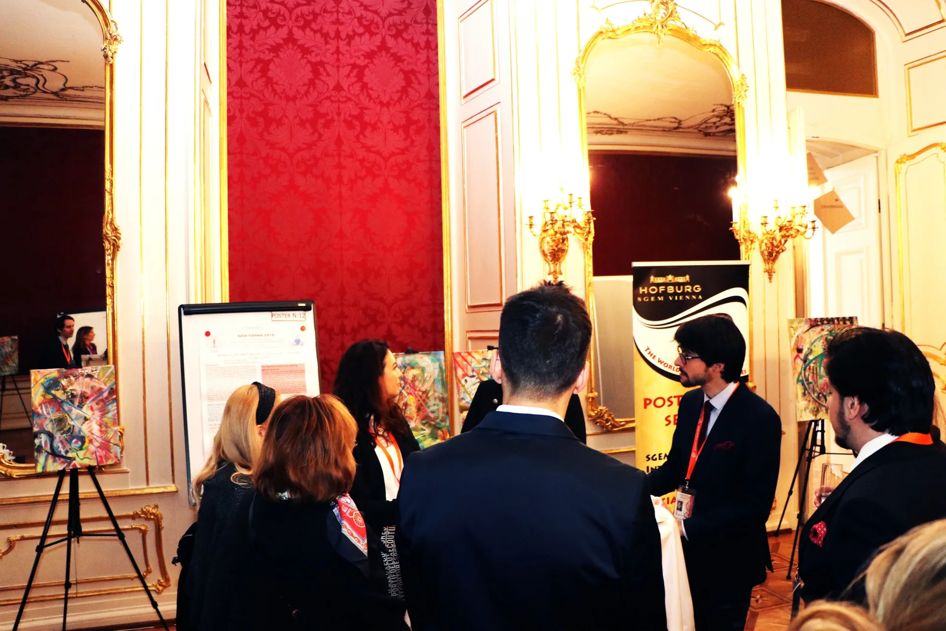 Delegates browsing scientific posters in an ornate room