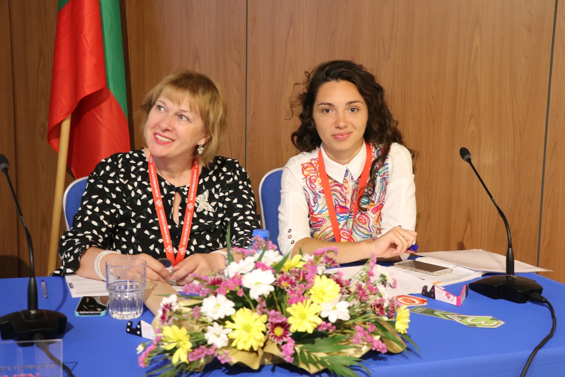 Two session chairs at a blue table with flowers