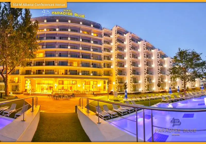 Paradise Blue Hotel and outdoor swimming pool at dusk