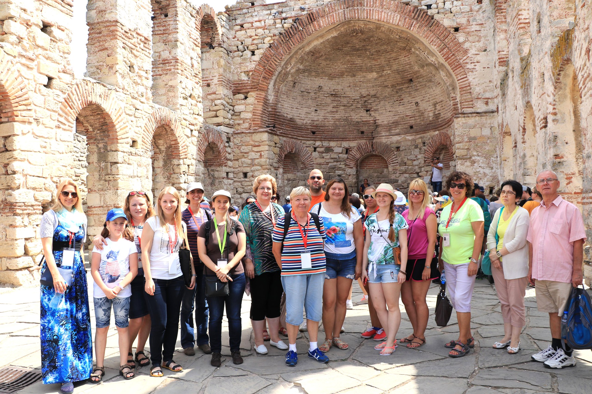 Conference participants visiting historic stone ruins