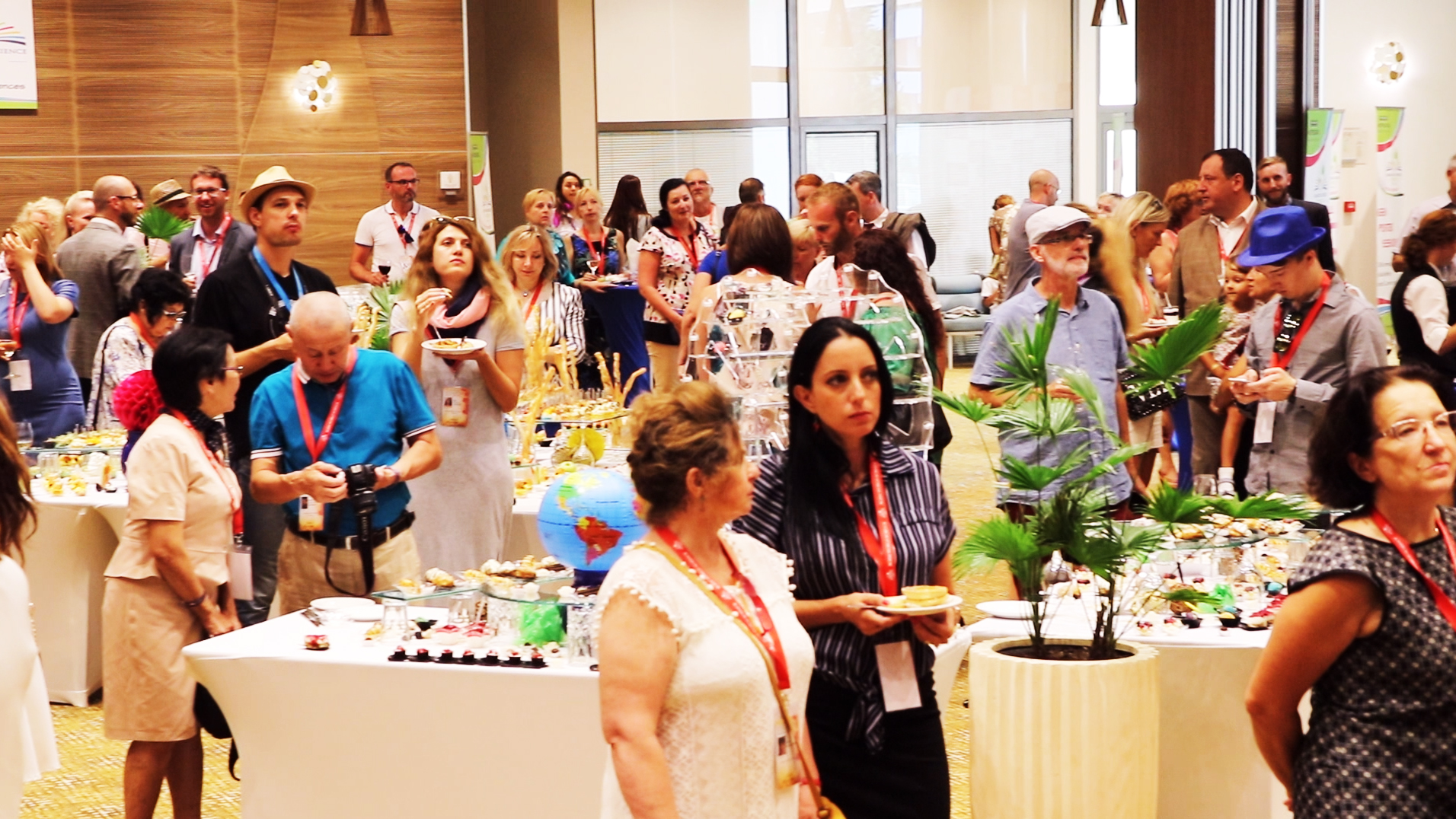 Conference participants gathered around tables at a reception