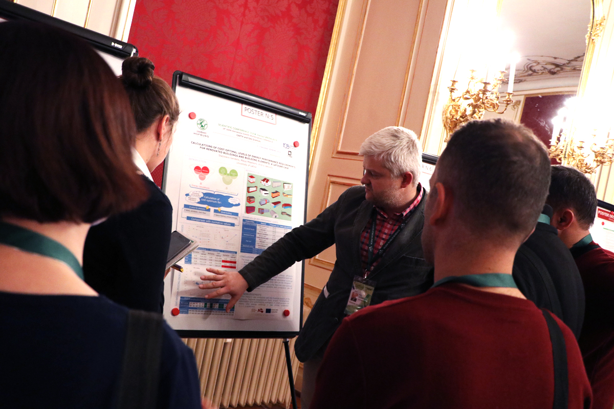 Researchers discussing a scientific poster at an SGEM session