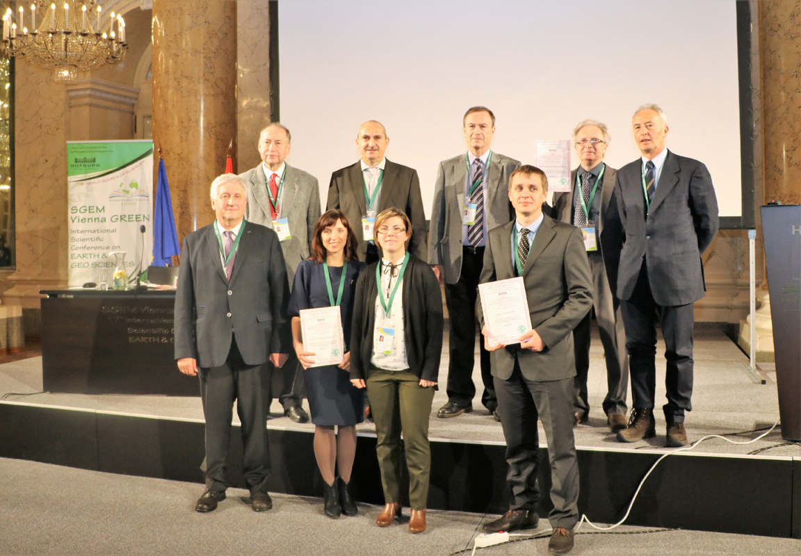 SGEM delegates and award recipients posing on a stage