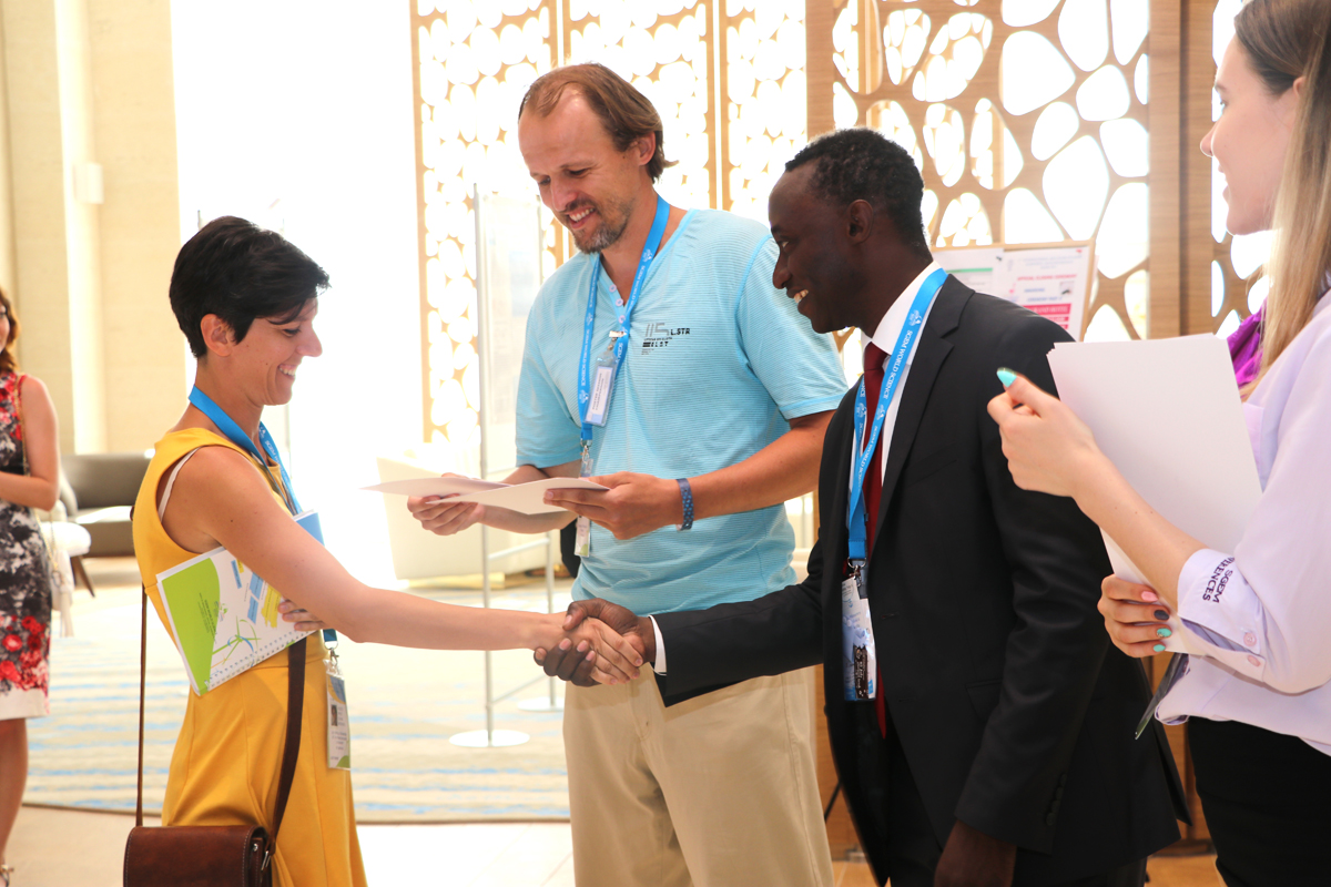 A delegate receiving congratulations and a certificate