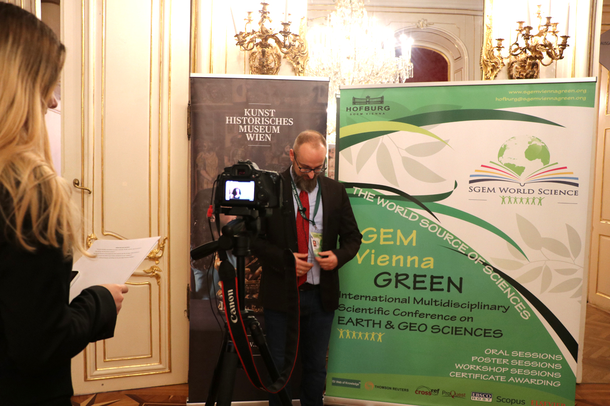 An interview recorded beside an SGEM Vienna GREEN banner