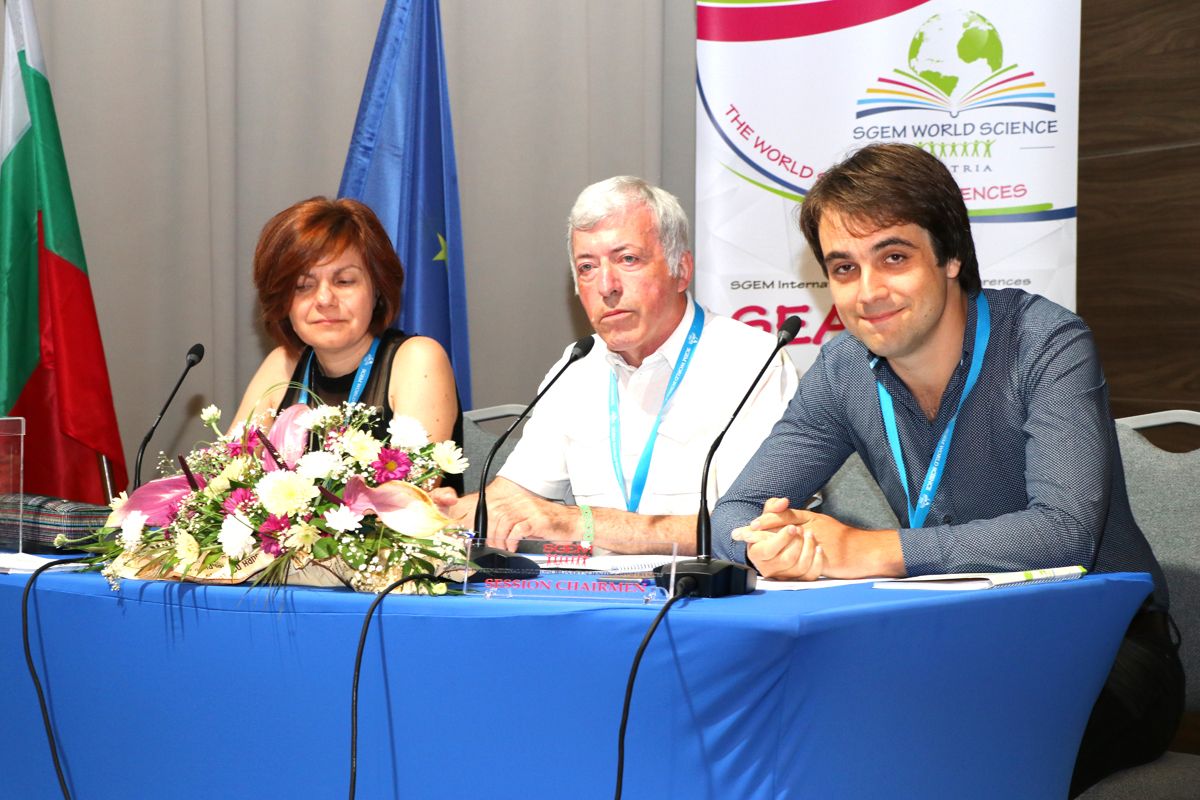 Three SGEM session chairs at a blue conference table