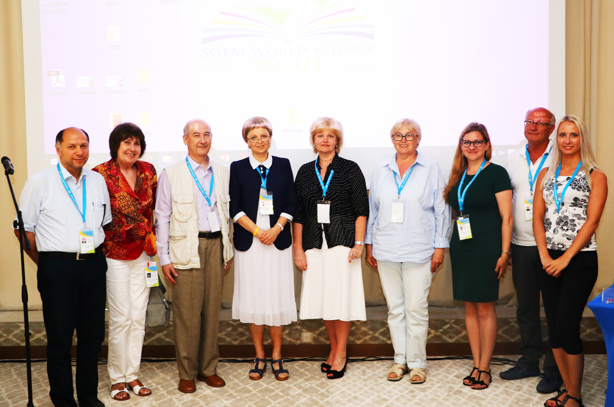 SGEM award recipients posing together in front of a presentation screen