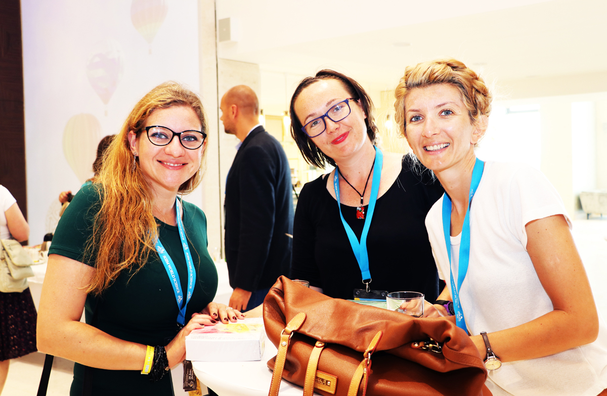 Three smiling delegates during an SGEM conference break