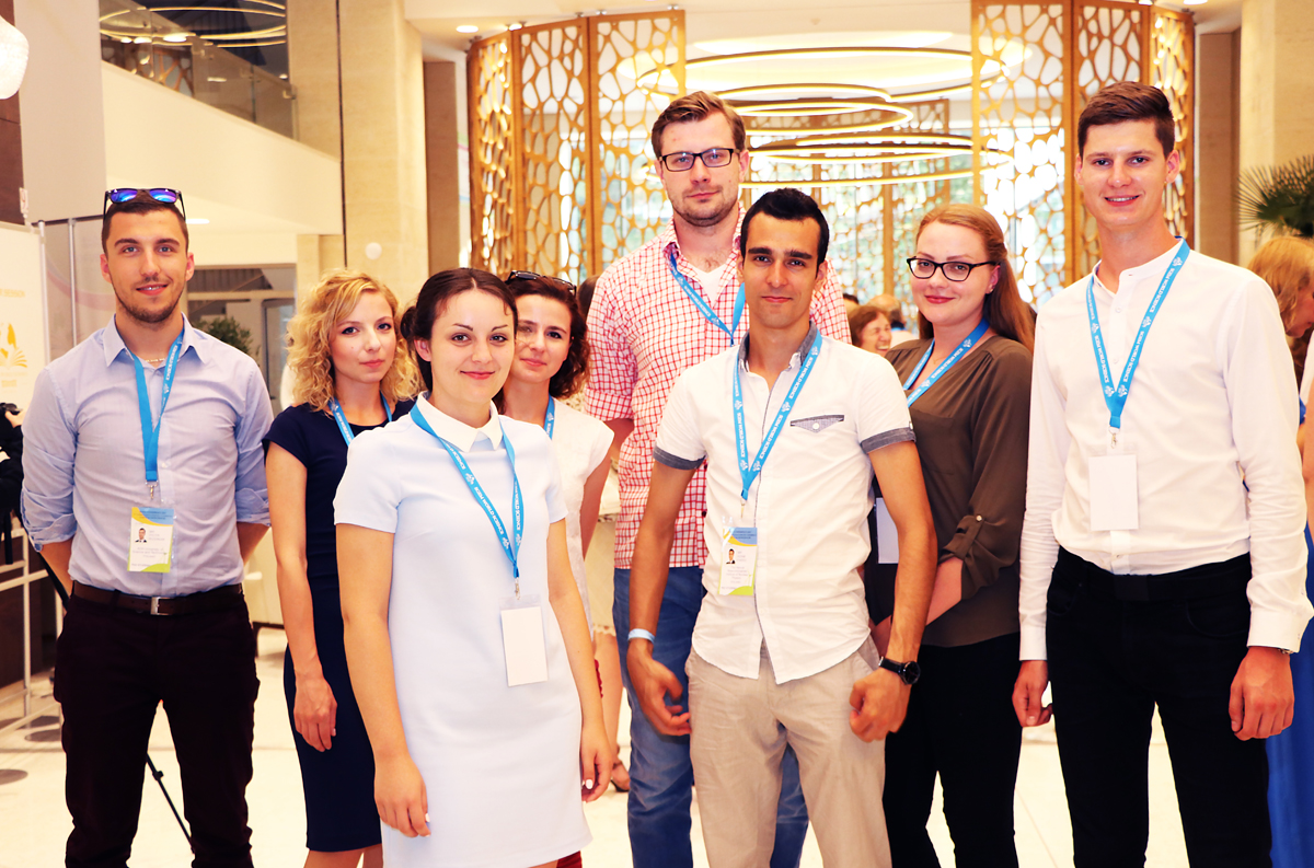 A group of young delegates in the conference foyer