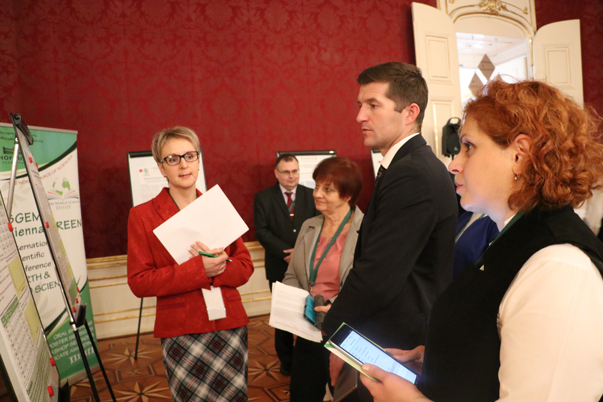 Researchers listening to a scientific poster presentation