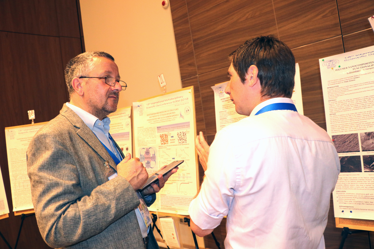 Two researchers discussing scientific posters