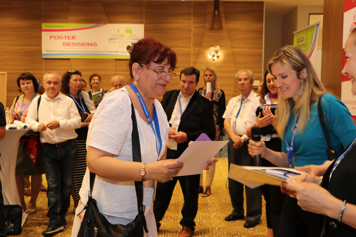 A delegate receiving a certificate during an SGEM presentation