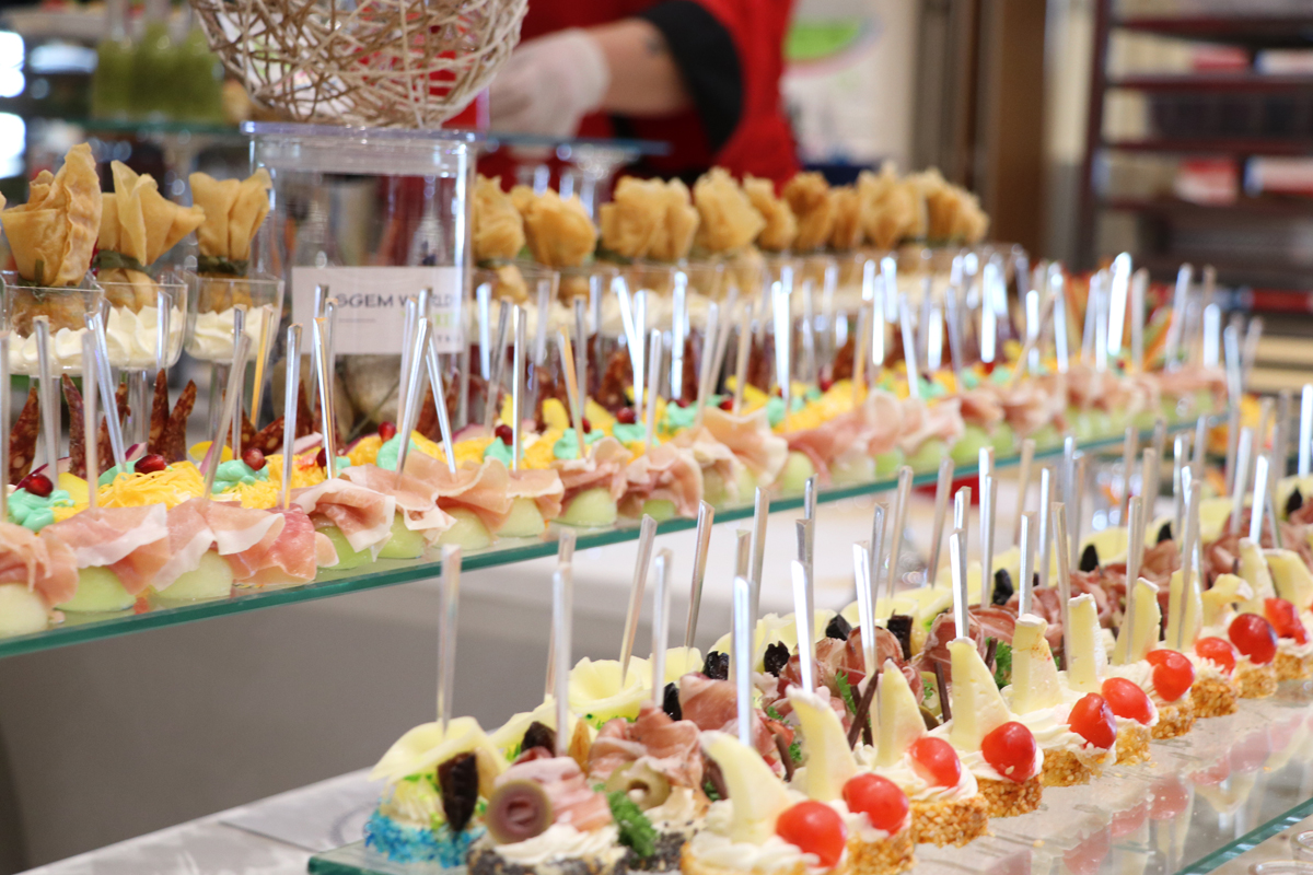 Rows of canapés and small desserts at a conference buffet