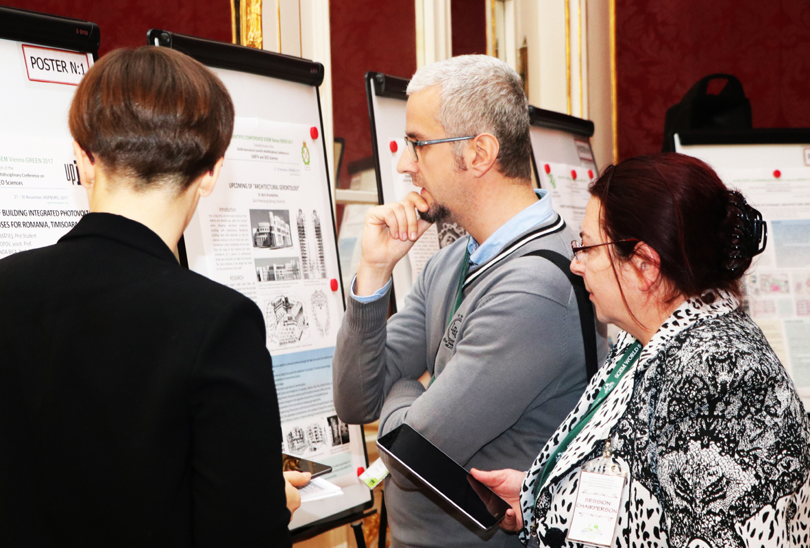 Researchers examining a poster during an SGEM session