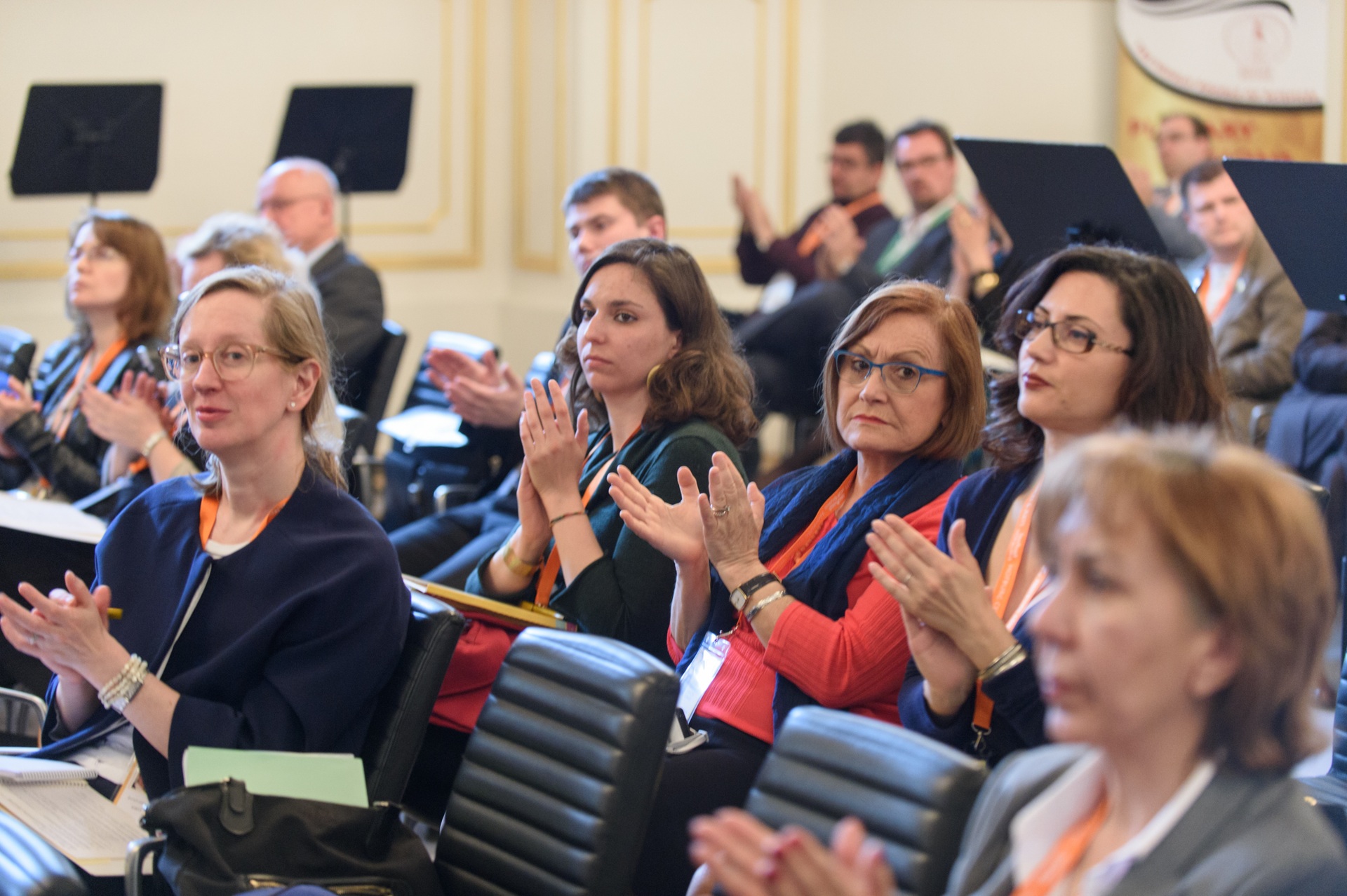 Conference participants applauding a speaker
