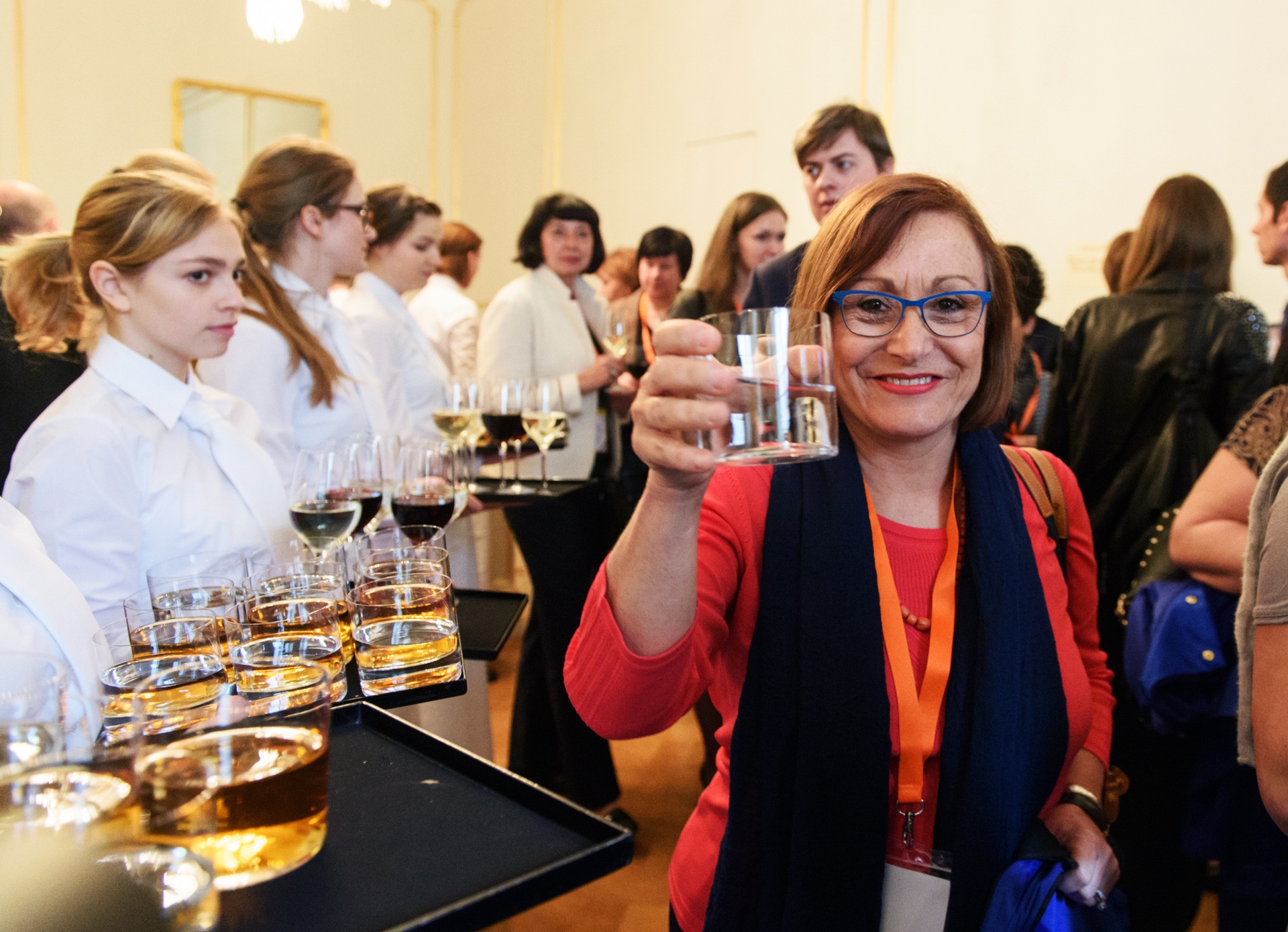 A delegate raising a glass during a conference reception
