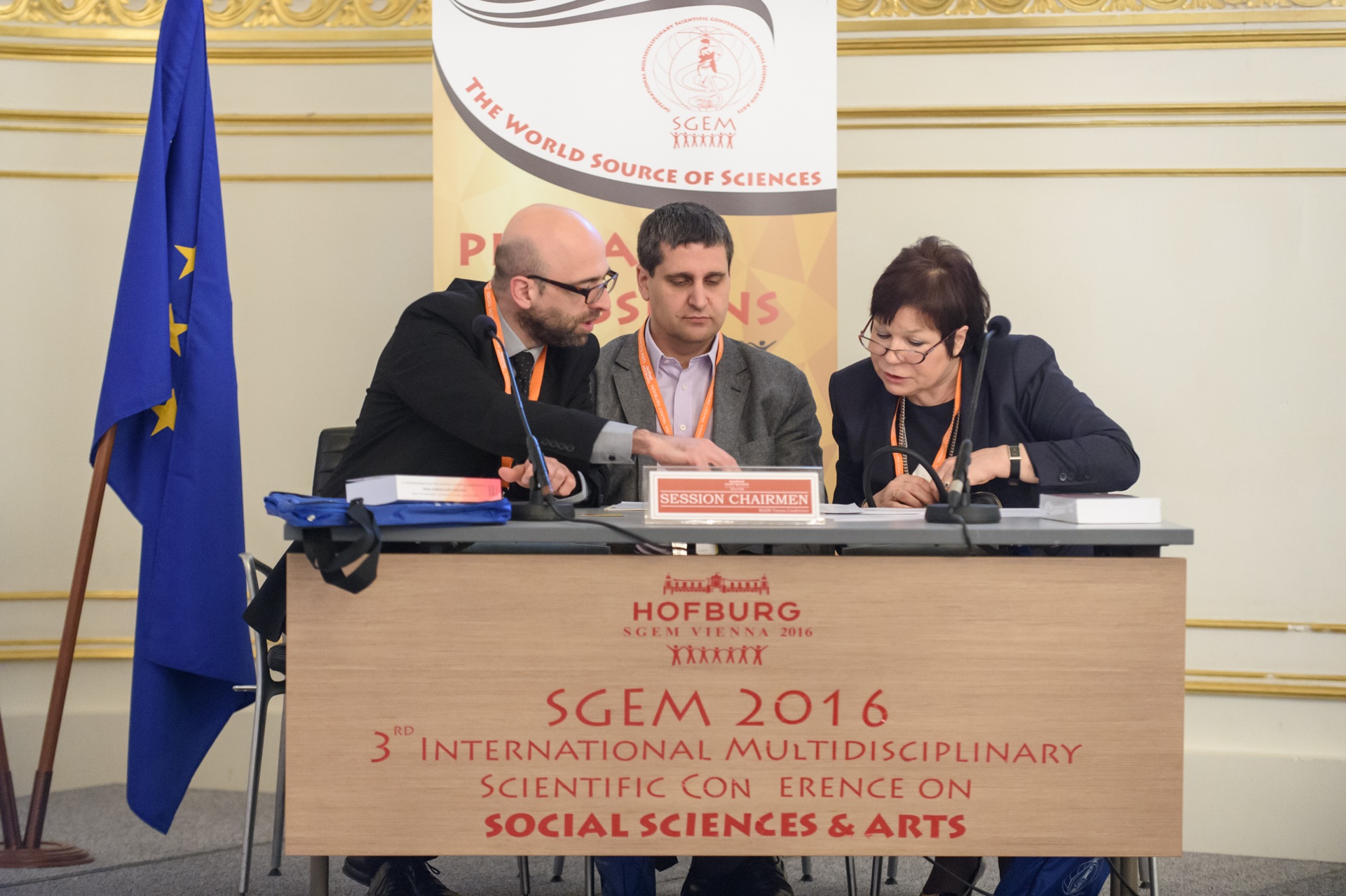 Three SGEM Vienna 2016 session chairs consulting at a lectern