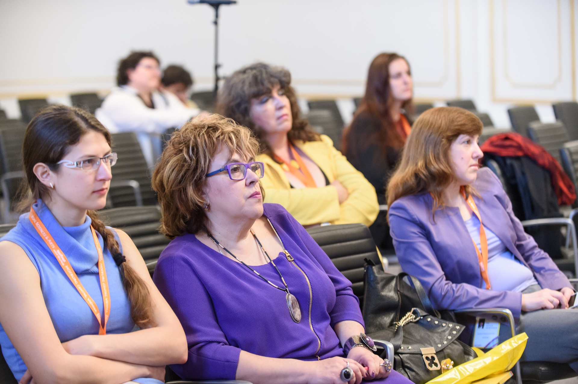 Conference delegates watching a presentation from auditorium seats
