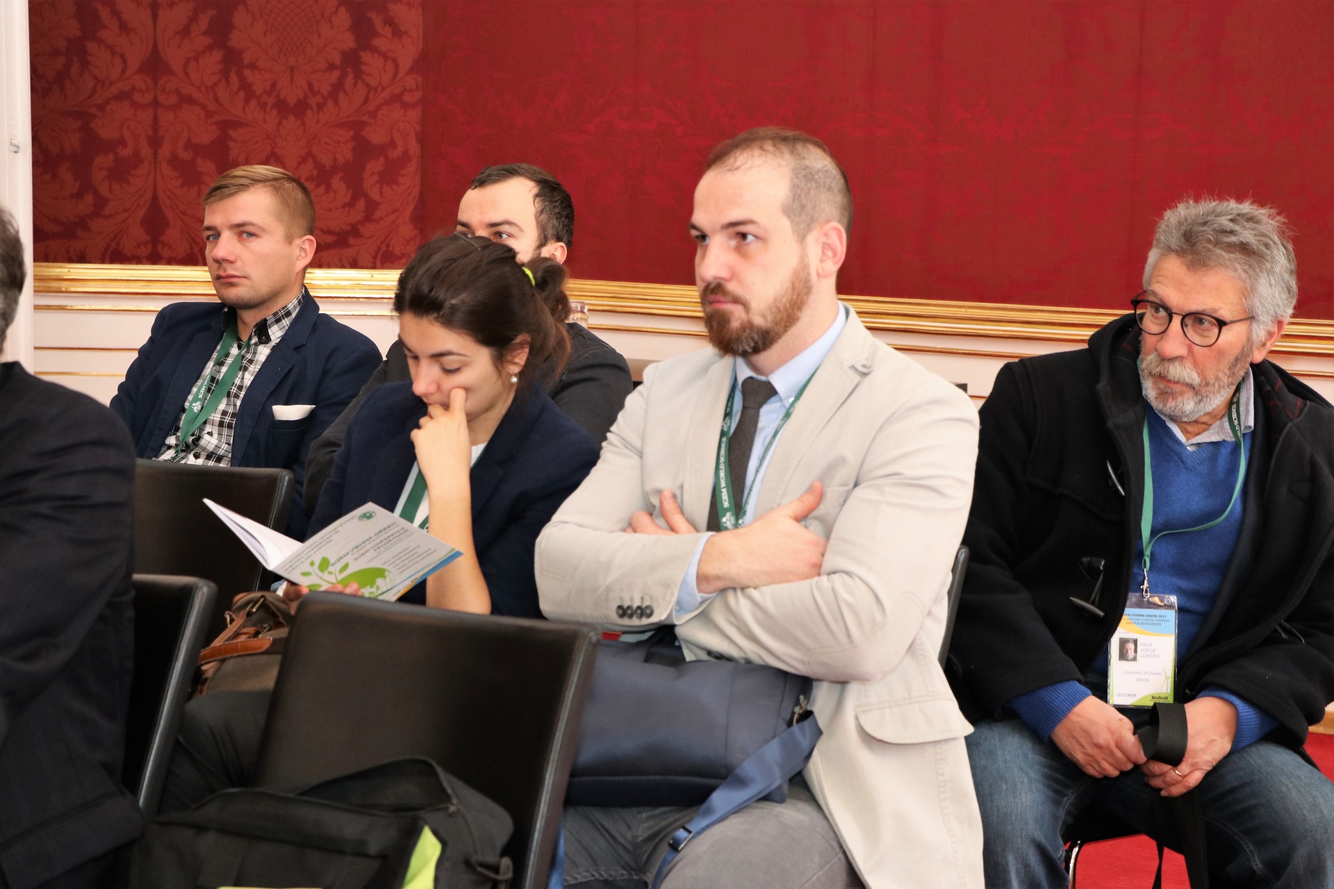 Researchers listening to a conference discussion