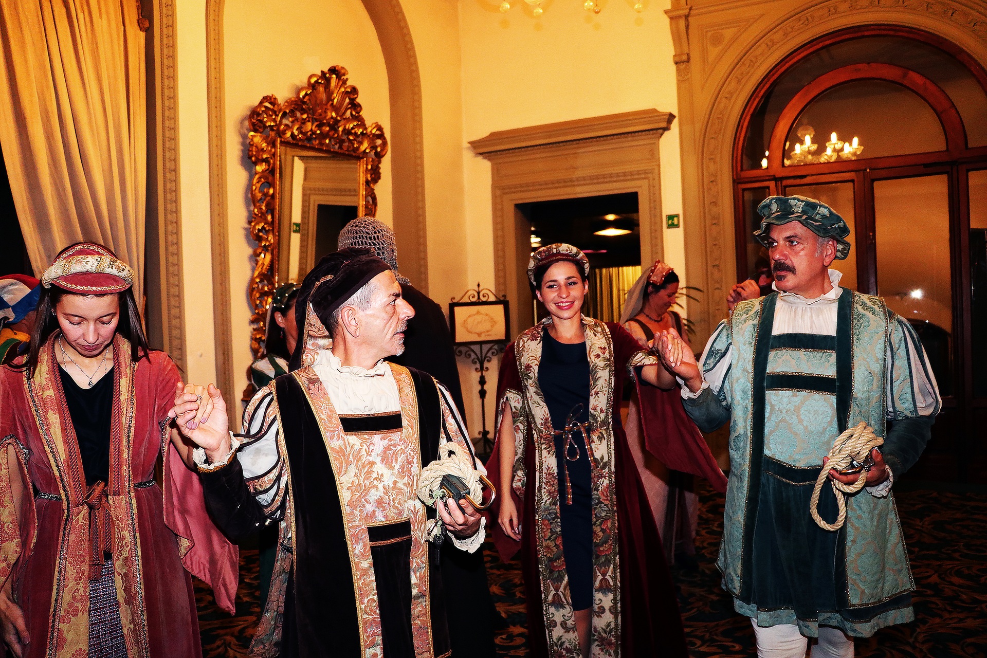 Performers in Renaissance-style costumes at a conference cultural event