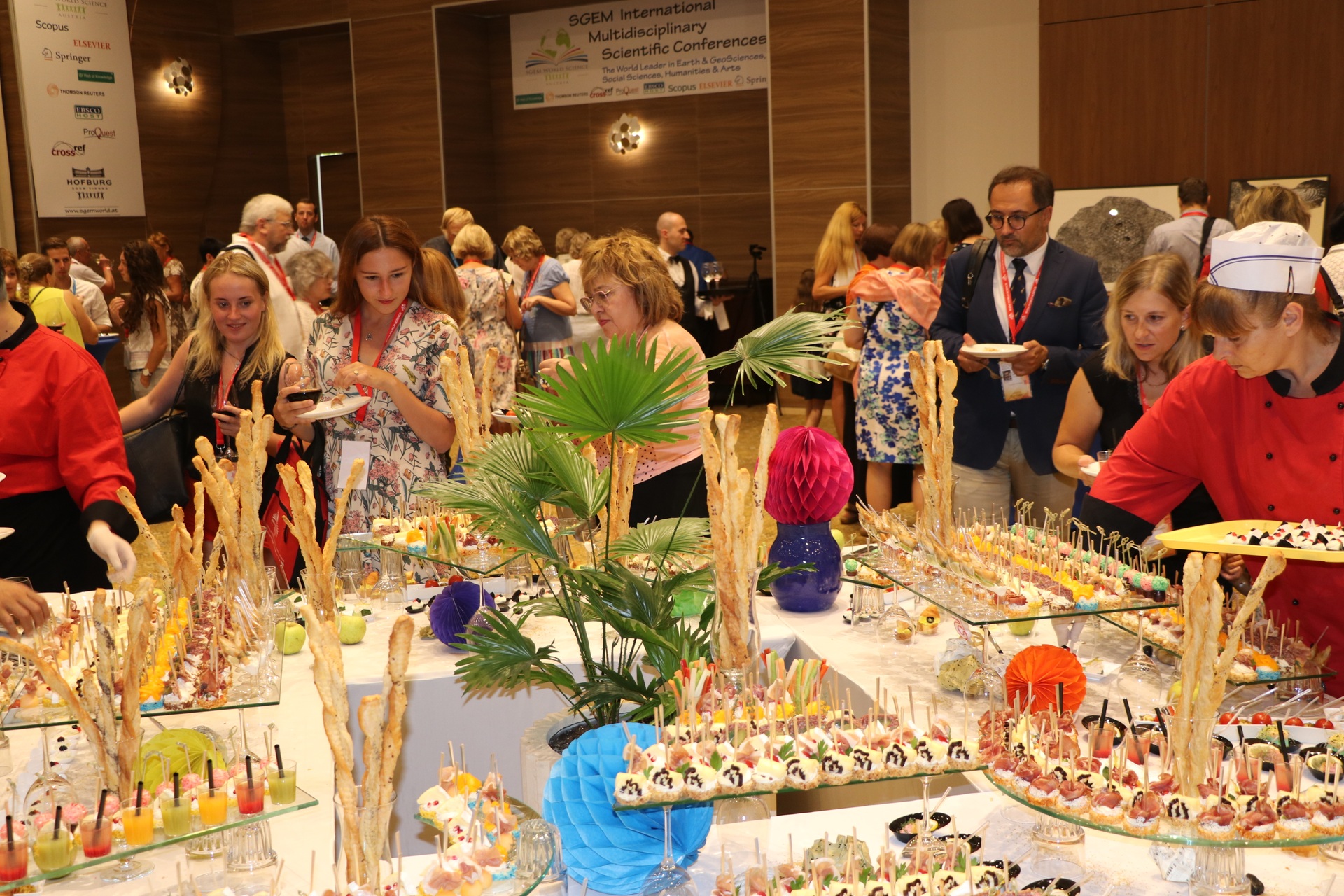 Conference guests selecting food from a decorated buffet