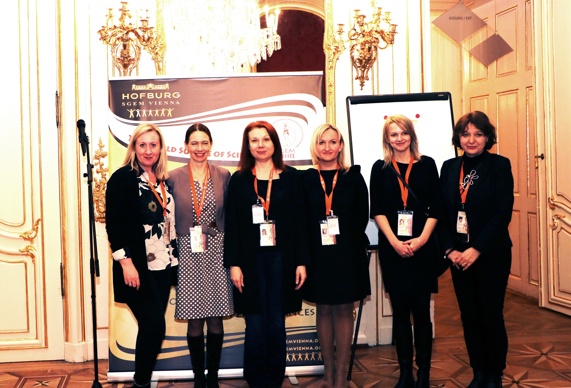 Conference participants posing together with glass awards