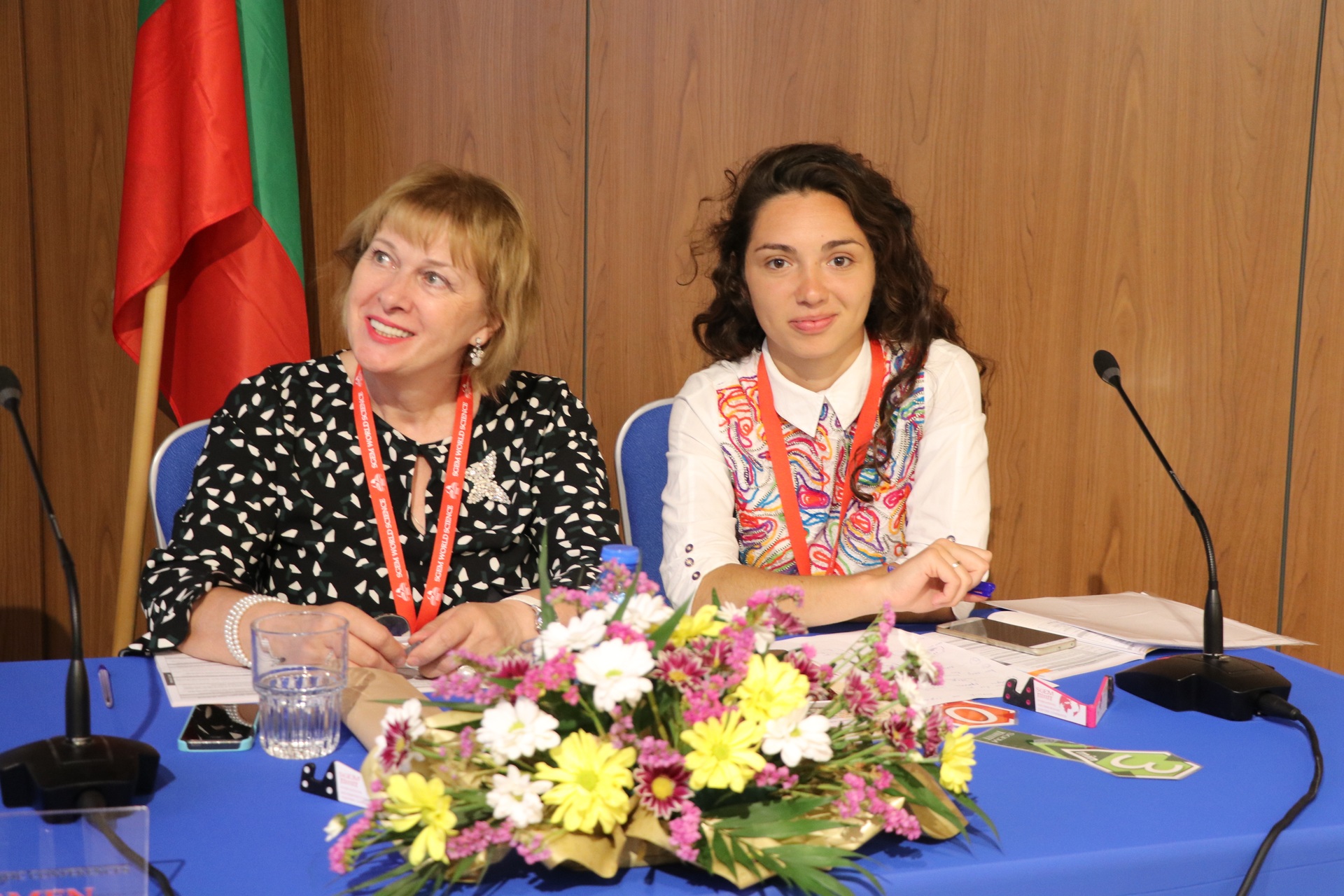 Two session chairs at a blue table with flowers