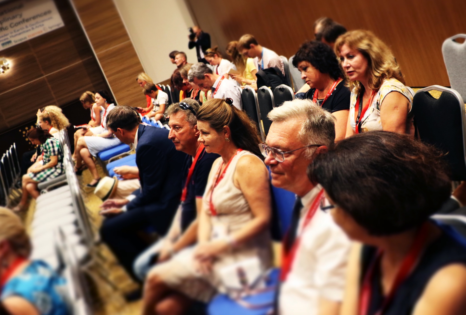 Conference delegates following a session from rows of seats