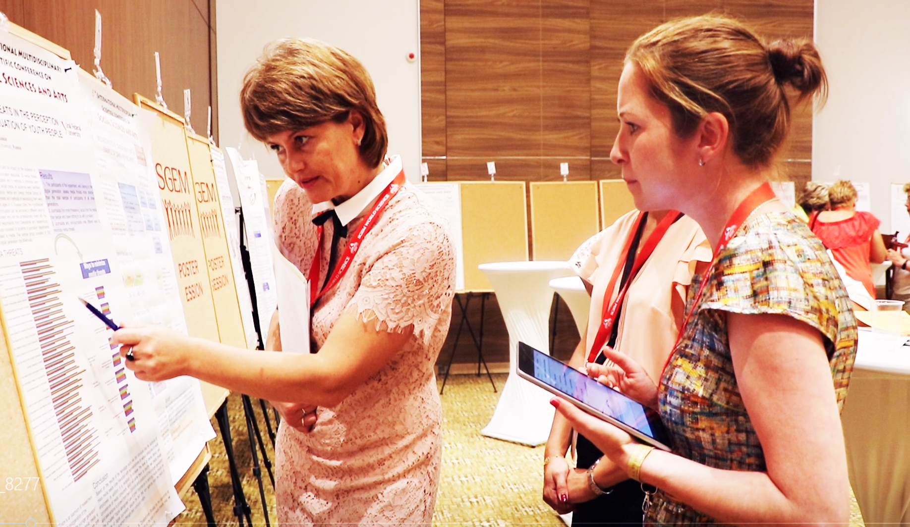 Two delegates discussing a scientific poster