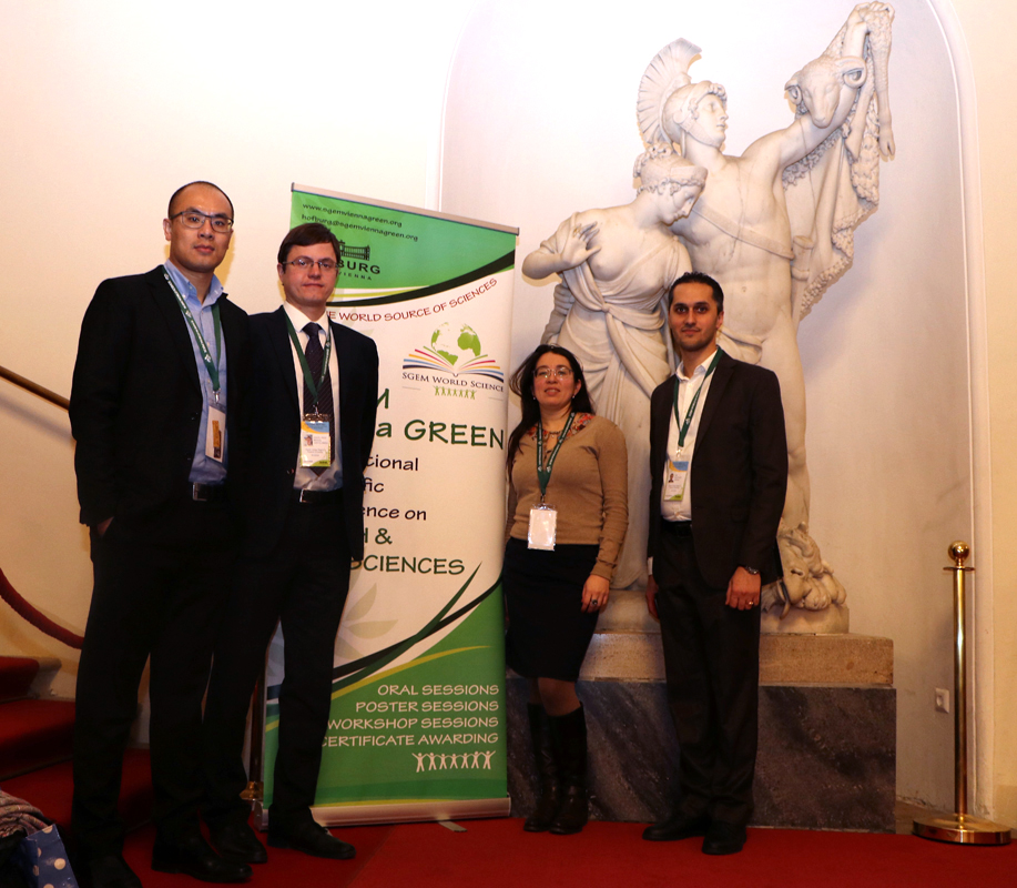 Delegates beside an SGEM Vienna GREEN banner and a sculpture