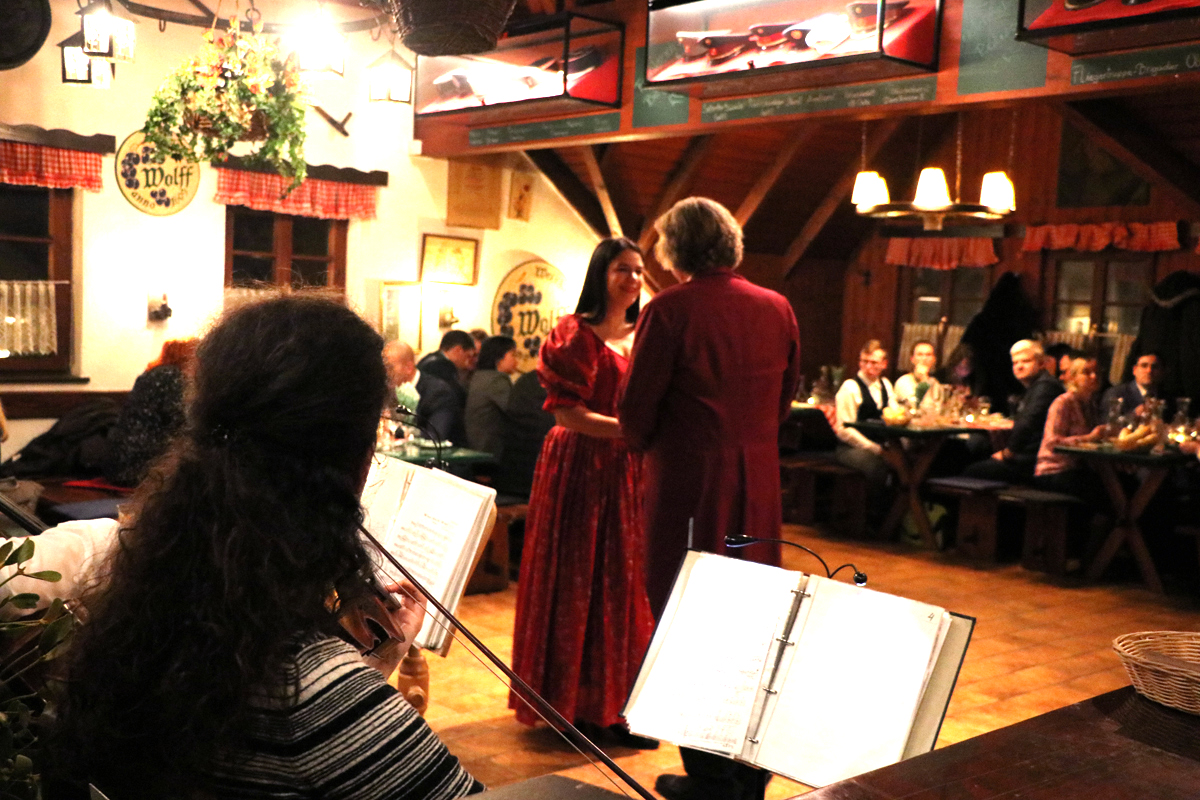 A singer and musicians performing during a conference dinner