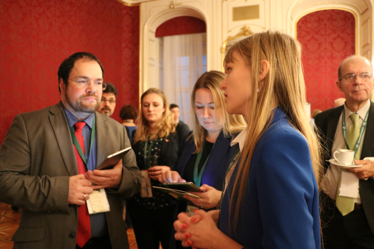 Delegates chatting over refreshments between conference sessions