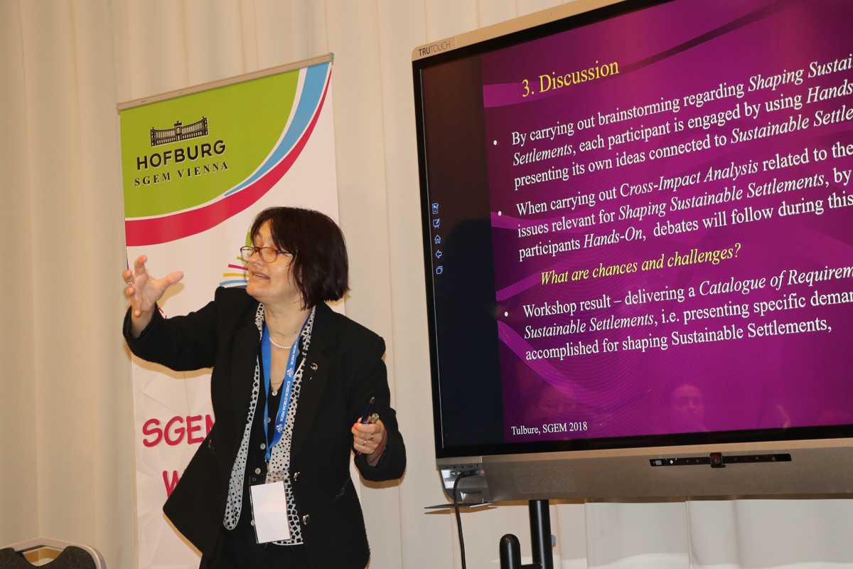 A researcher explaining a discussion slide on a presentation screen