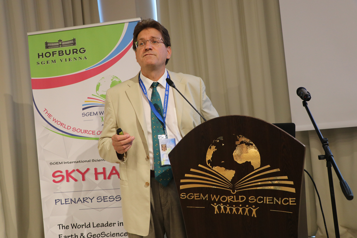 A scientist speaking at an SGEM World Science lectern
