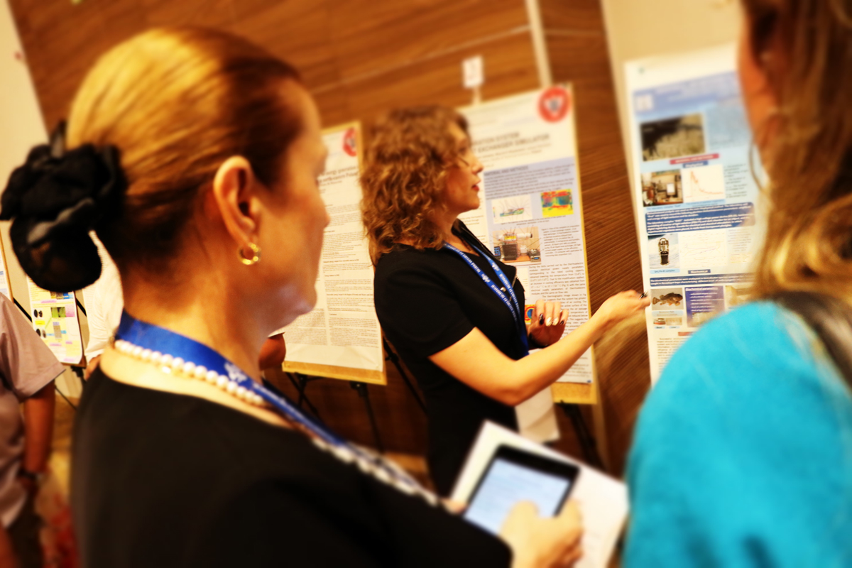 A researcher explaining her scientific poster to colleagues