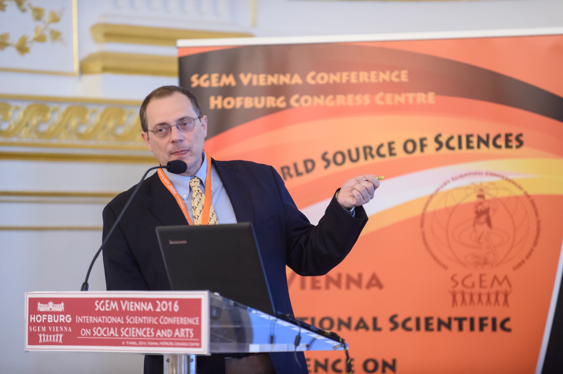 A researcher gesturing during an SGEM Vienna presentation