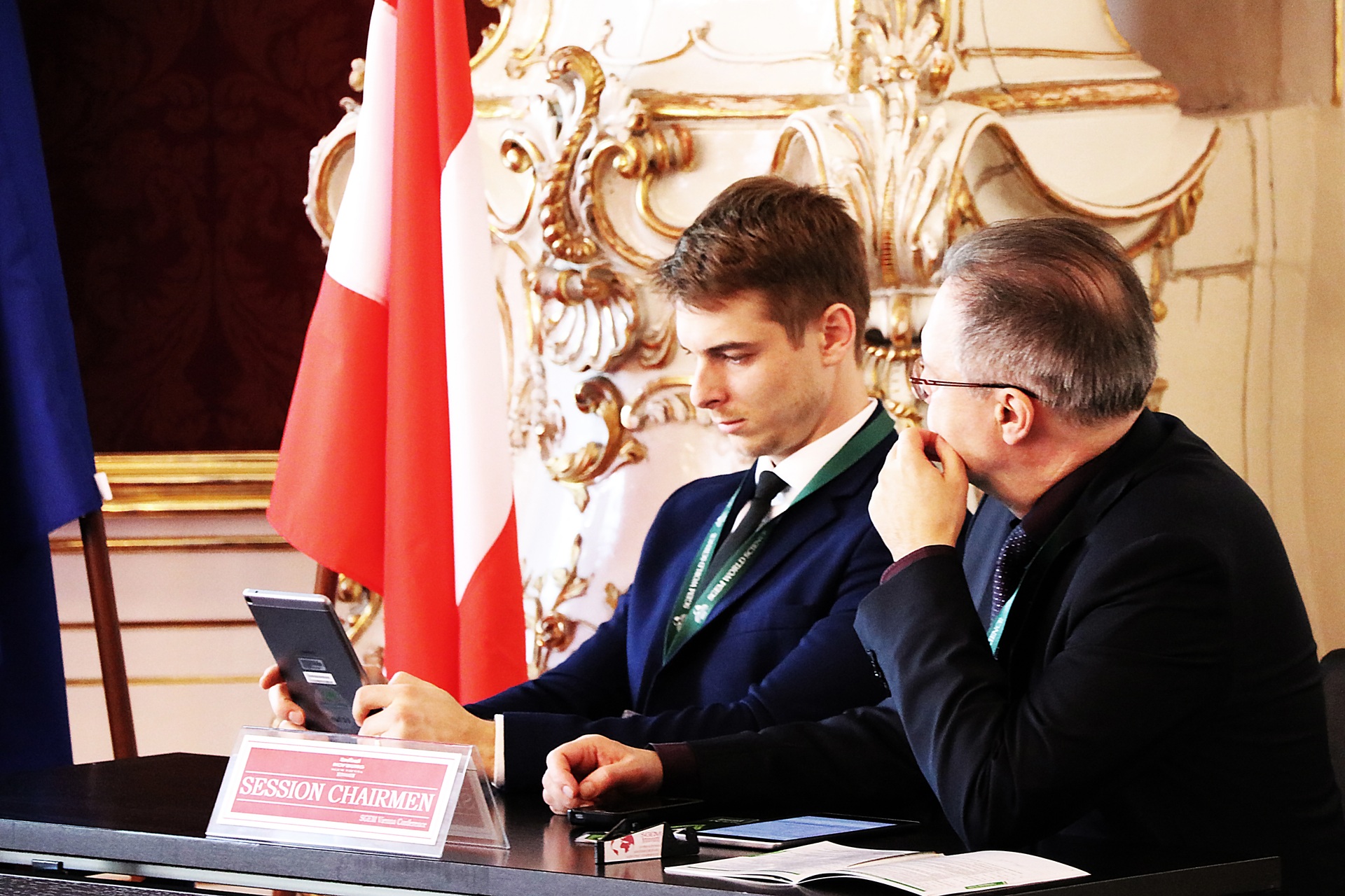 Two session chairpersons consulting at an SGEM conference table