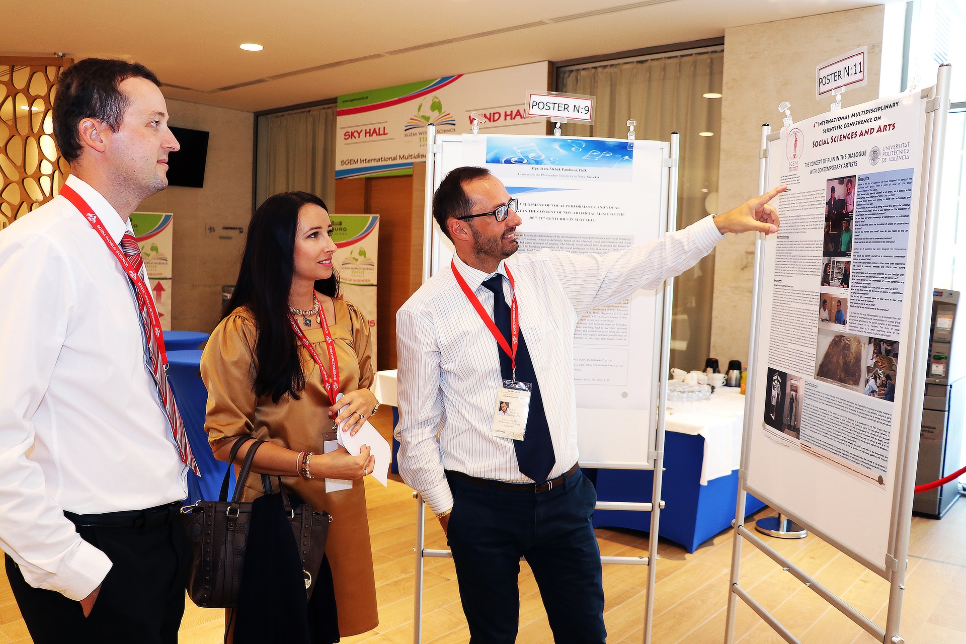 Three participants examining a scientific poster with its presenter