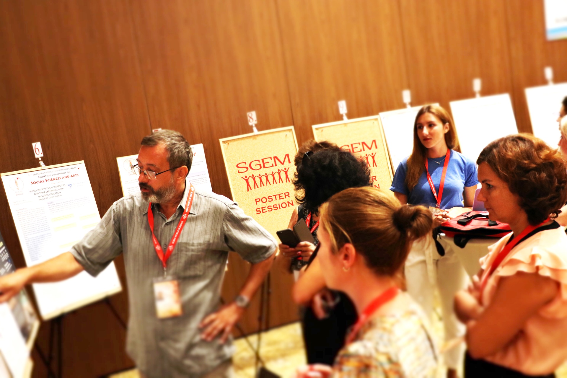 A researcher explaining his poster to a group of delegates